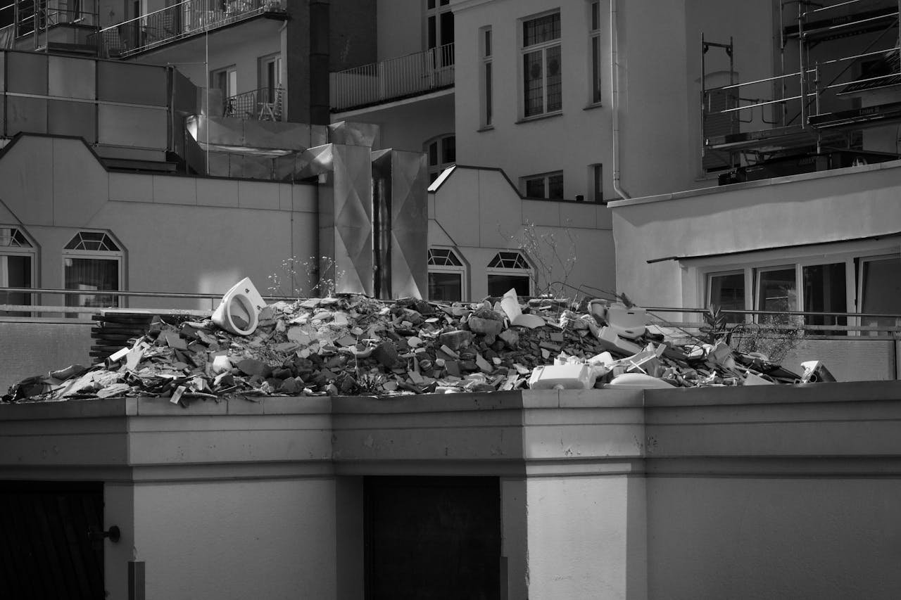 Monochrome view of construction debris on a rooftop in a city setting.